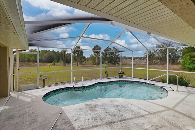 outdoor pool with a lanai, a patio area, and a lawn