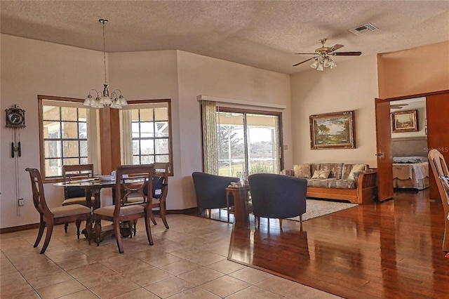 dining area with a textured ceiling, plenty of natural light, and visible vents