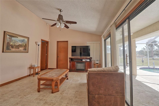 living room featuring baseboards, lofted ceiling, ceiling fan, a textured ceiling, and light tile patterned flooring