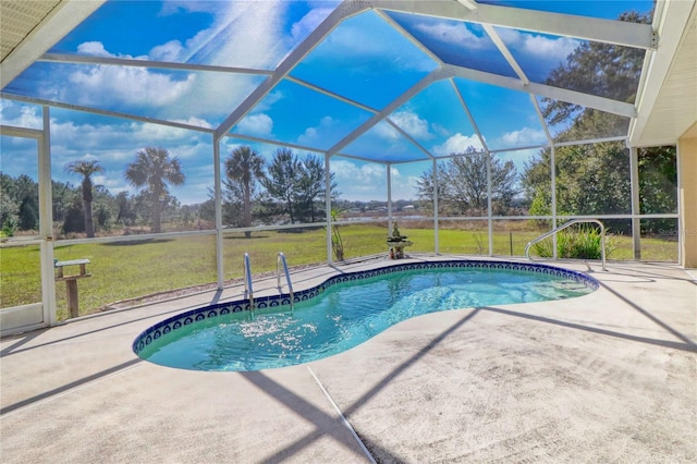 pool featuring a lanai, a patio area, and a lawn