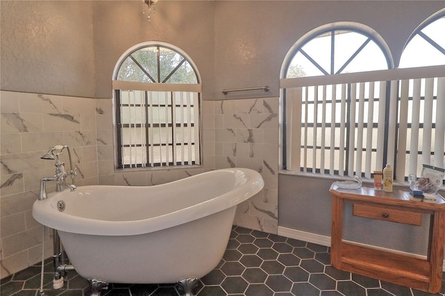 bathroom featuring a soaking tub and tile walls