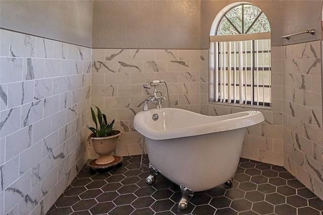 full bathroom featuring a freestanding tub and tile walls