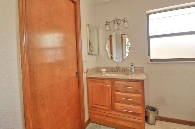 bathroom featuring baseboards and vanity