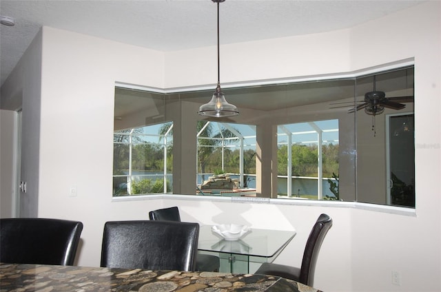 dining space with a sunroom and a ceiling fan