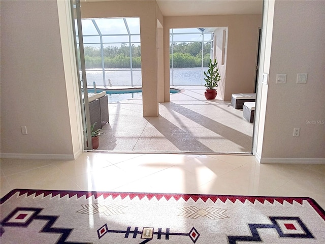 interior space with a sunroom, baseboards, and tile patterned floors