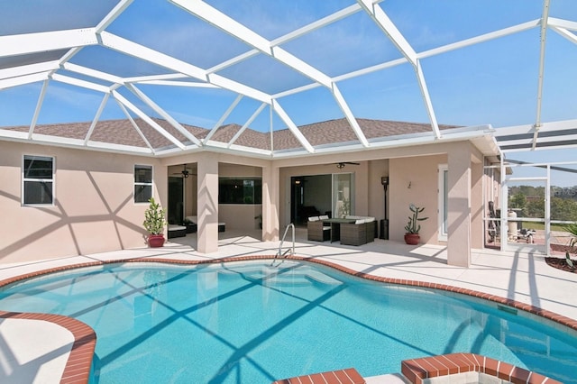 pool featuring a lanai, a patio area, ceiling fan, and an outdoor hangout area