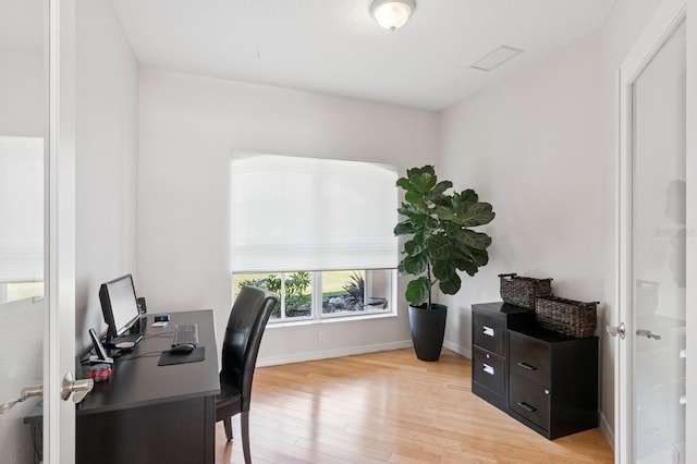 office space featuring light wood-style floors and baseboards