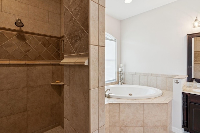 full bathroom with a jetted tub, vanity, and a walk in shower