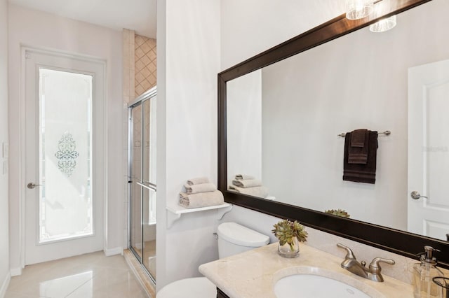 bathroom with toilet, tile patterned floors, a shower stall, and vanity