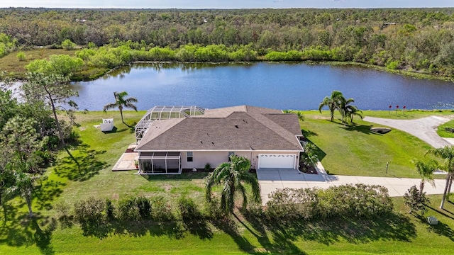 birds eye view of property featuring a water view and a wooded view