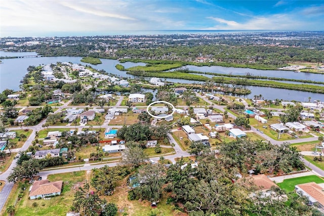 drone / aerial view featuring a residential view and a water view