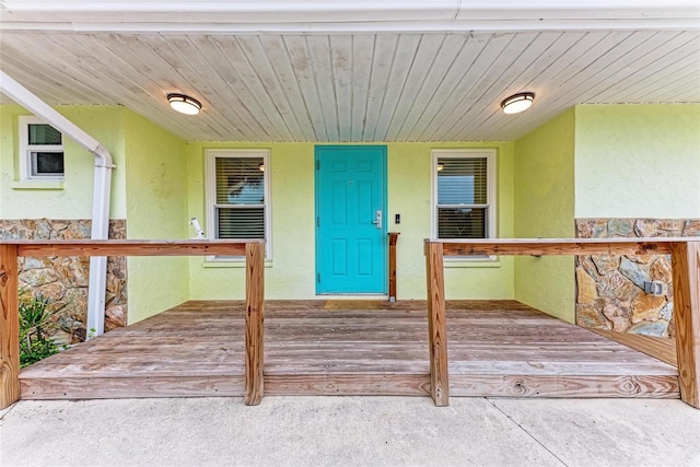 property entrance with stucco siding