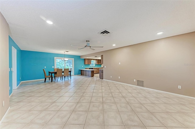 interior space with open floor plan, light countertops, visible vents, and pendant lighting