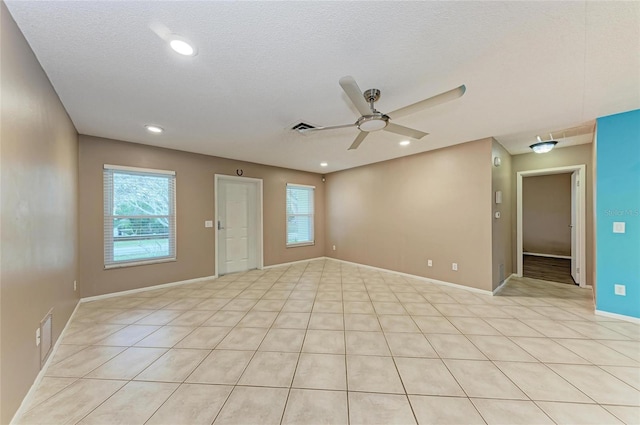 empty room featuring a ceiling fan, recessed lighting, a textured ceiling, and baseboards