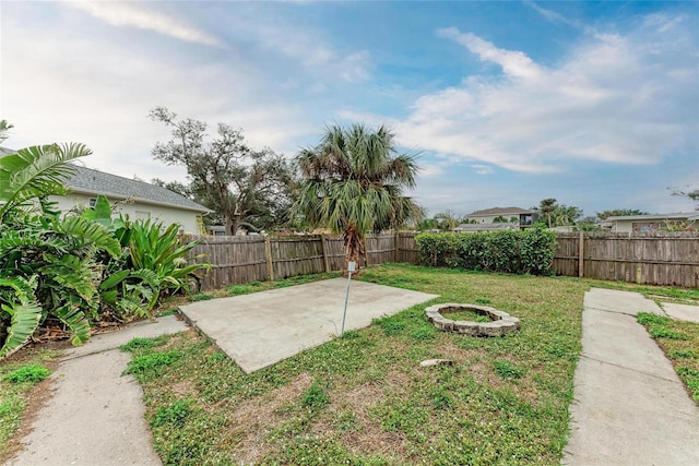 view of yard with a patio, an outdoor fire pit, and a fenced backyard