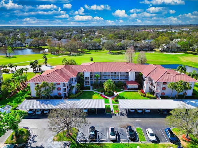 birds eye view of property featuring golf course view and a water view