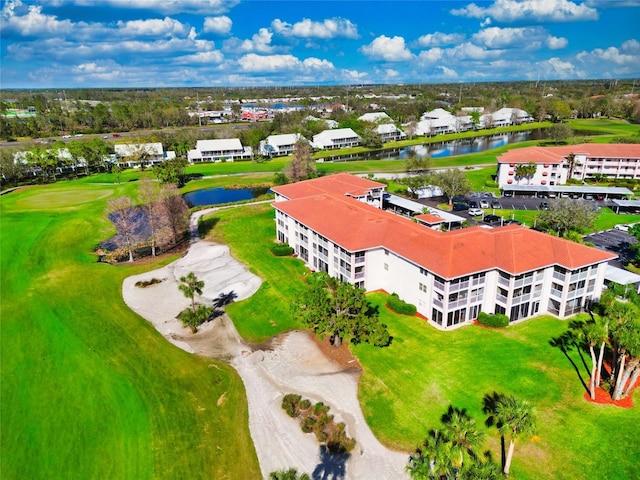 birds eye view of property with a water view and view of golf course