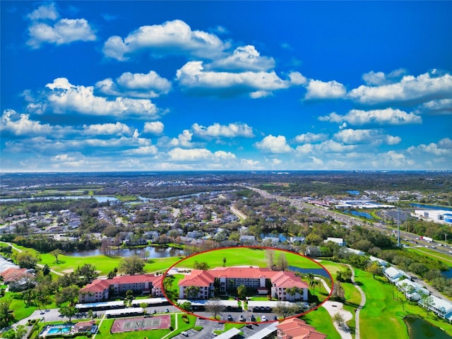 drone / aerial view with a water view and golf course view