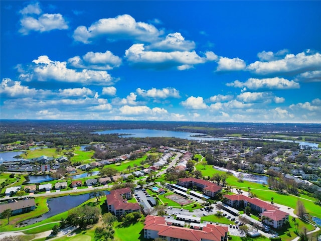 drone / aerial view with a water view and a residential view