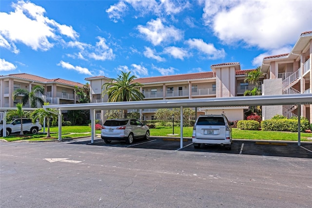 covered parking lot featuring a residential view