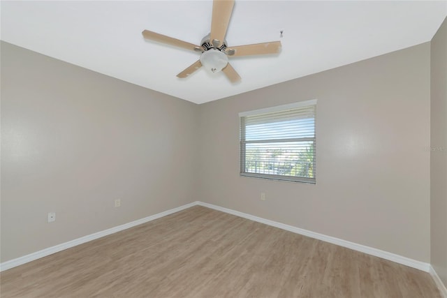 unfurnished room with light wood finished floors, ceiling fan, and baseboards