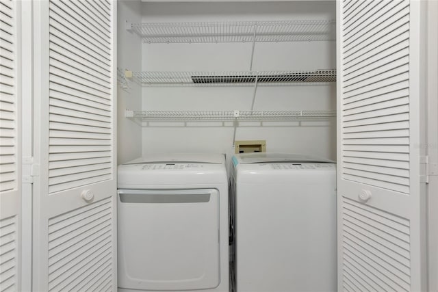 washroom with laundry area and washing machine and dryer