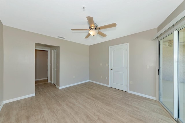 empty room with baseboards, visible vents, ceiling fan, and light wood finished floors