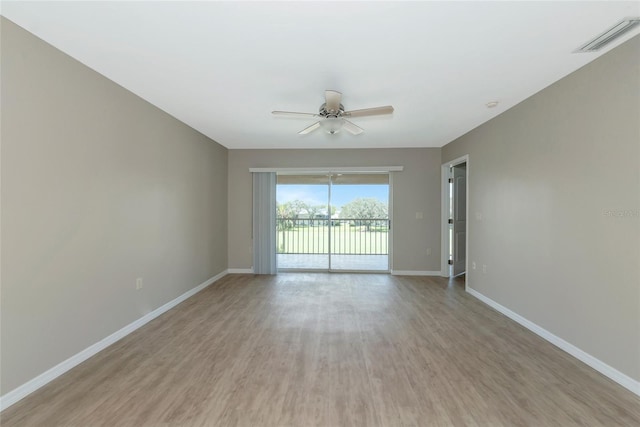 unfurnished room with ceiling fan, light wood-style floors, visible vents, and baseboards