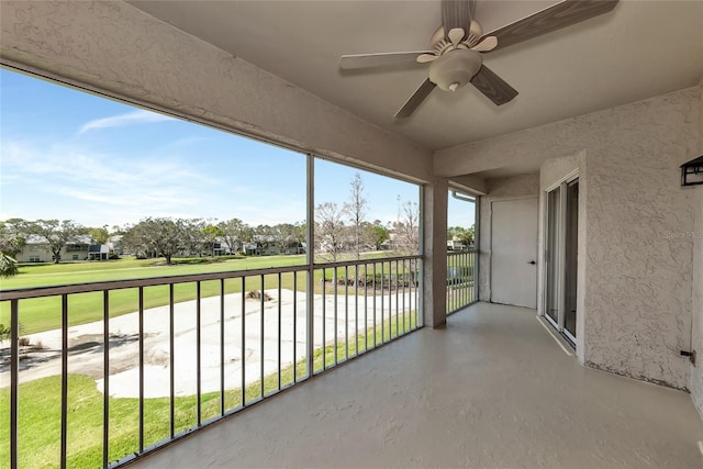 unfurnished sunroom with ceiling fan