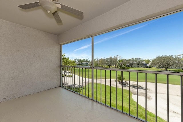 unfurnished sunroom featuring ceiling fan