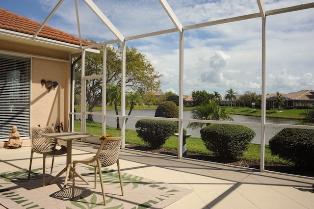 sunroom / solarium featuring a water view