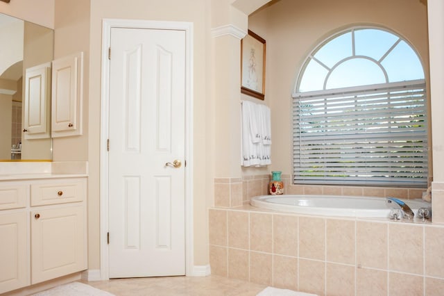 bathroom featuring tile patterned floors, vanity, and a garden tub