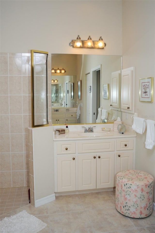 full bathroom featuring a walk in shower, tile patterned flooring, and vanity