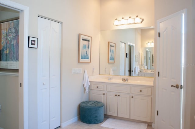 bathroom featuring a closet, tile patterned floors, and vanity