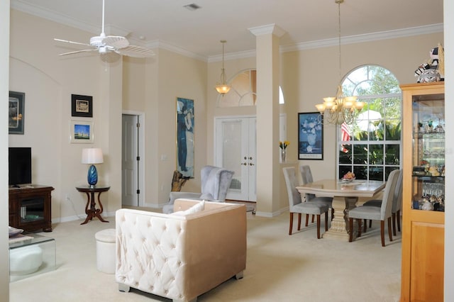 living area featuring light carpet, ceiling fan with notable chandelier, crown molding, and a towering ceiling