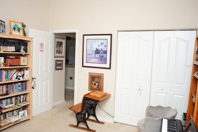 living area featuring carpet floors and baseboards