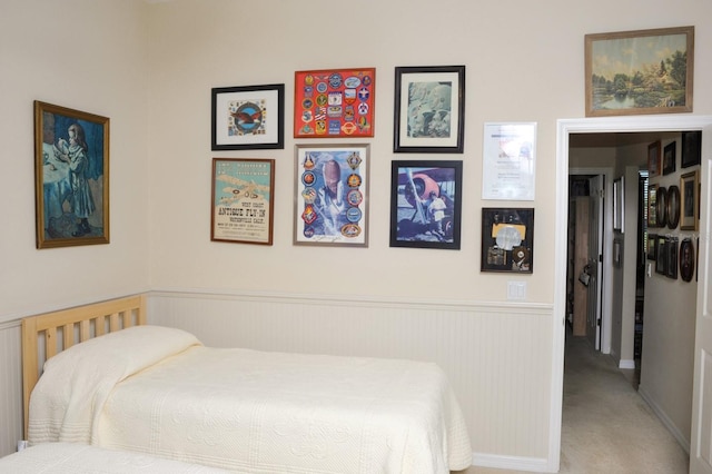 carpeted bedroom with wainscoting