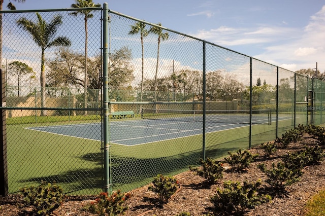 view of sport court featuring fence