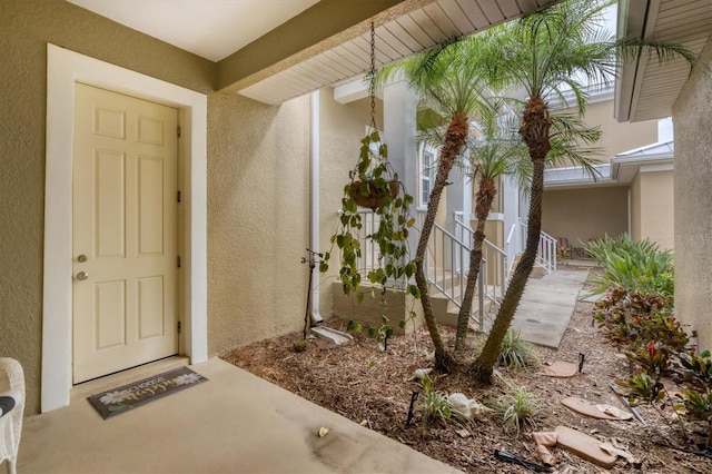 property entrance with stucco siding