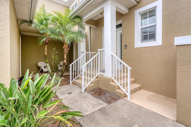 property entrance with stucco siding