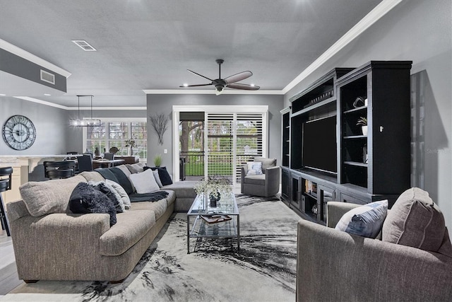 living area with a ceiling fan, crown molding, wood finished floors, and visible vents