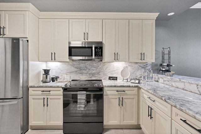 kitchen featuring light stone counters, stainless steel appliances, and backsplash