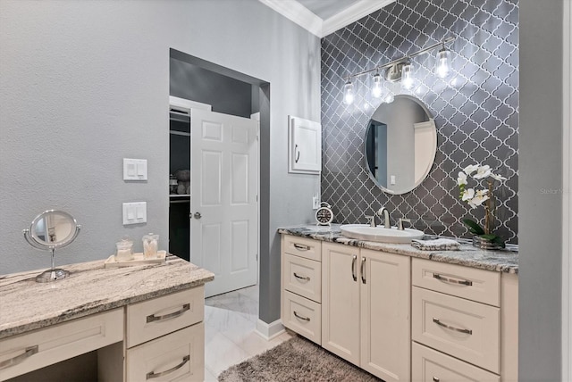 bathroom with wallpapered walls, vanity, and ornamental molding