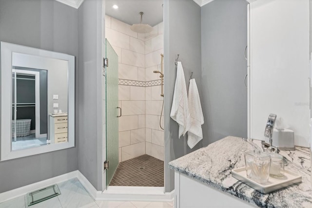 full bathroom with baseboards, vanity, and a shower stall