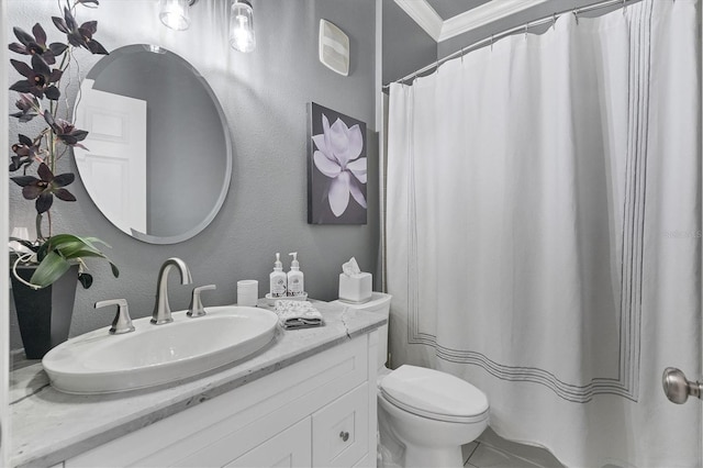 bathroom with vanity, crown molding, toilet, and a textured wall