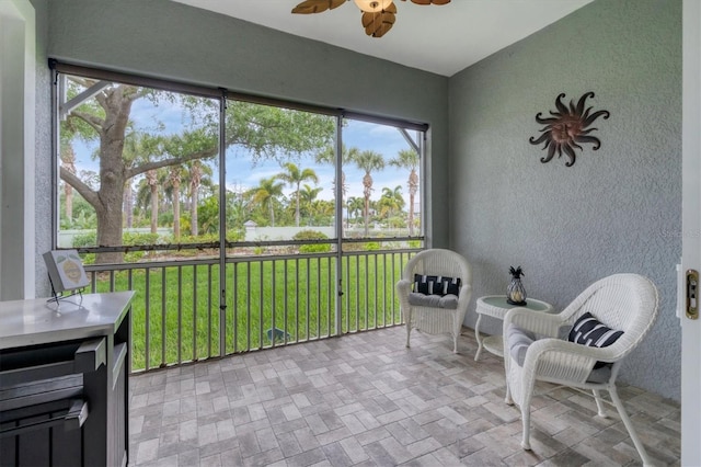 sunroom with a ceiling fan