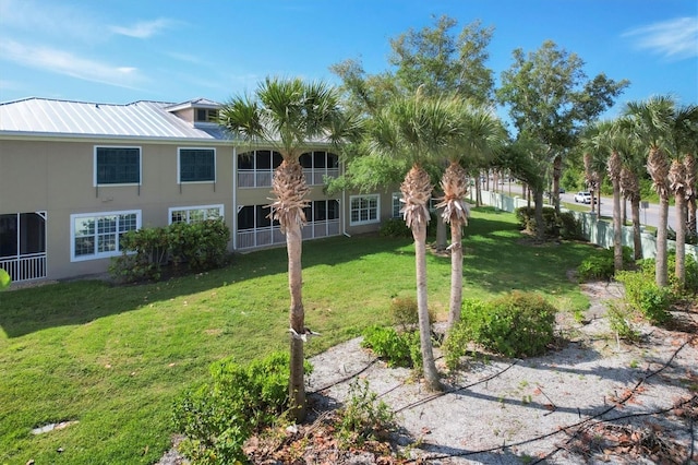 view of property's community with a yard and fence