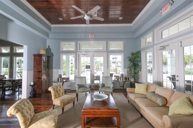 living room featuring french doors, dark wood-type flooring, wood ceiling, and ornamental molding