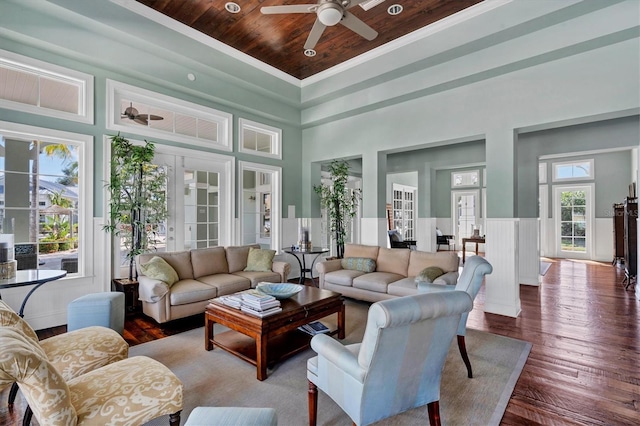 sunroom / solarium with ceiling fan, french doors, and wooden ceiling