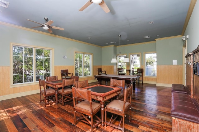 dining area with hardwood / wood-style floors, a healthy amount of sunlight, visible vents, and wainscoting